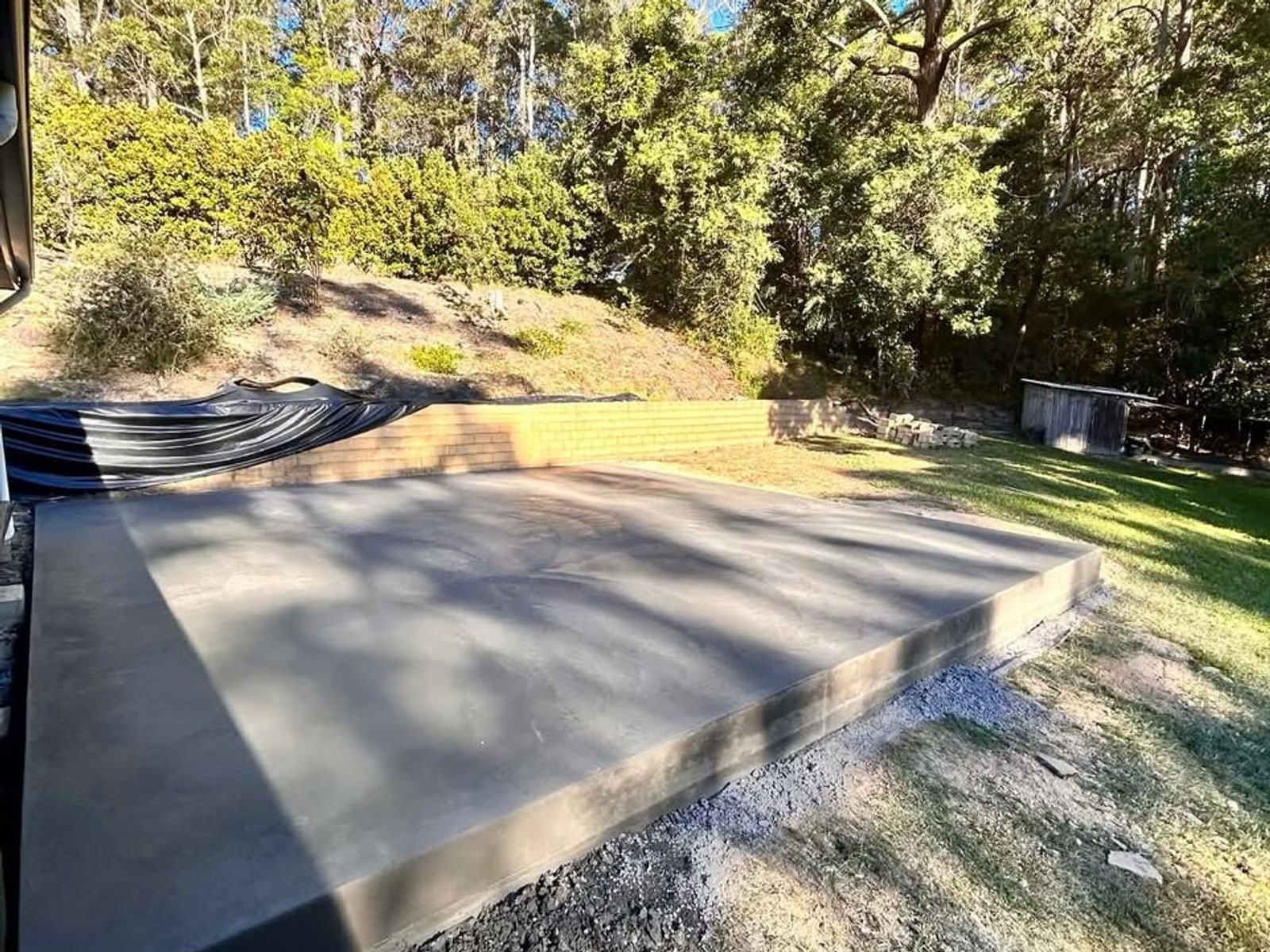 Finished concrete slab in eucalyptus bushland — Mid North Coast NSW backyard, ready for use